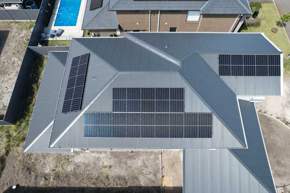 Aerial view of a residential building with solar panels.