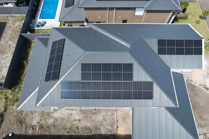 Aerial view of a residential building with solar panels.